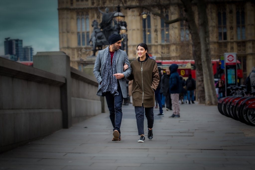 Sikhing Sikh couple walking in London